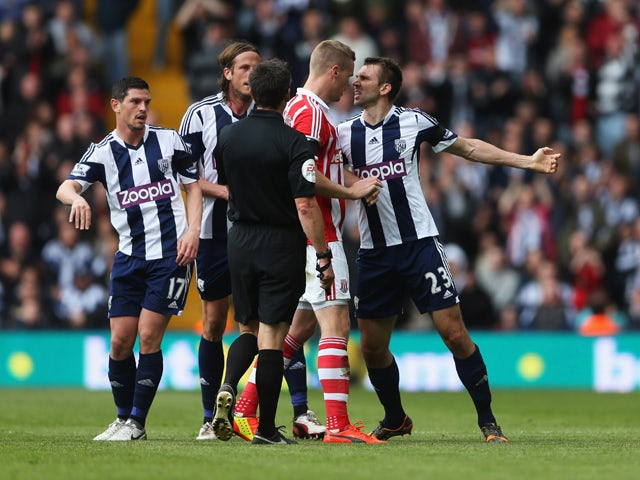 Gareth McAuley of West Bromwich Albion clashes with Ryan Shawcross of Stoke City as referee Lee Probert intervenes during the Barclays Premier League match between West Bromwich Albion and Stoke City at The Hawthorns on May 11, 2014