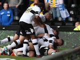 Derby's Will Hughes is mobbed by teammates after scoring the opening goal against Brighton during their play-off semi-final match on May 11, 2014