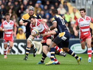 Shane Monahan of Gloucester is tackled by Chris Pennell of Worcester Warriors during the Aviva Premiership match between Worcester Warriors and Gloucester at Sixways Stadium on May 10, 2014