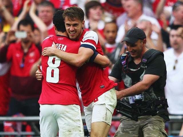 Aaron Ramsey of Arsenal celebrates with Mikel Arteta as he scores their third goal during the FA Cup with Budweiser Final match between Arsenal and Hull City at Wembley Stadium on May 17, 2014