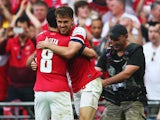 Aaron Ramsey of Arsenal celebrates with Mikel Arteta as he scores their third goal during the FA Cup with Budweiser Final match between Arsenal and Hull City at Wembley Stadium on May 17, 2014