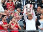 Arsene Wenger manager of Arsenal lifts the trophy in celebration alongside Lukas Podolski, Mikel Arteta and Thomas Vermaelen after the FA Cup with Budweiser Final match between Arsenal and Hull City at Wembley Stadium on May 17, 2014
