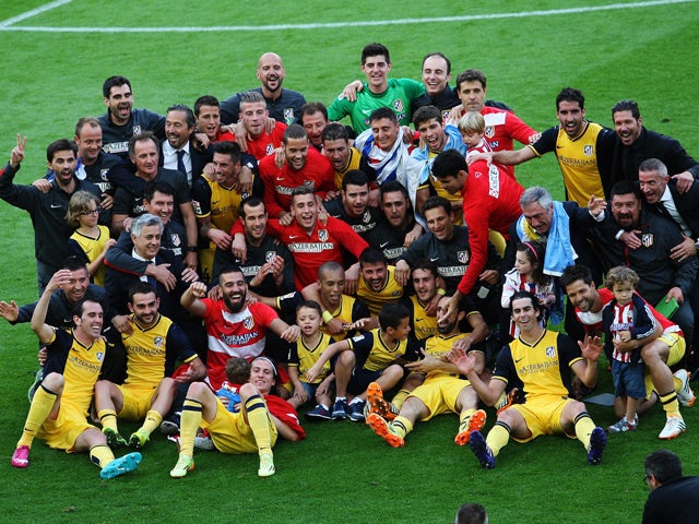 Atletico de Madrid's football players and staff pose as they celebrate their Spanish league title at the end of the Spanish league football match FC Barcelona vs Club Atletico de Madrid at the Camp Nou stadium in Barcelona on May 17, 2014