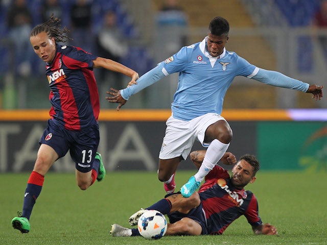 Balde Diao Keita (C) of SS Lazio competes for the ball with Diego Laxalt (L) and Michele Pazienza of Bologna FC during the Serie A match on May 18, 2014