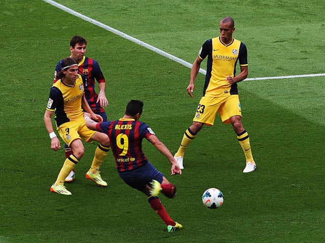 Barcelona's Chilean forward Alexis Sanchez scores the opener during the Spanish league football match FC Barcelona vs Club Atletico de Madrid at the Camp Nou stadium in Barcelona on May 17, 2014