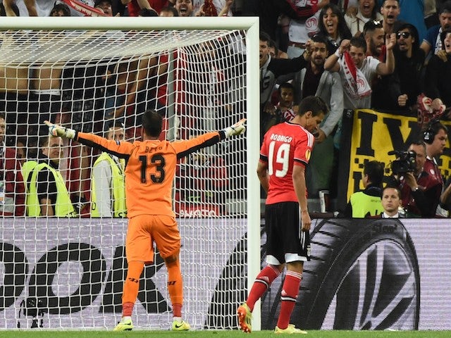 Sevilla's Portuguese goalkeeper Beto (L) celebrates after Benfica's Spanish forward Rodrigo Machado misses a penalty during the penalty shoot out during the UEFA Europa league final on May 14, 2014