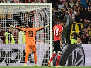 Sevilla's Portuguese goalkeeper Beto (L) celebrates after Benfica's Spanish forward Rodrigo Machado misses a penalty during the penalty shoot out during the UEFA Europa league final on May 14, 2014