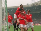Eric Cantona is mobbed by his Manchester United teammates after scoring against Chelsea in the FA Cup final on May 14, 1994.