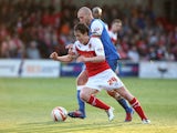 Nigel Penn of York City battles for the ball with Josh Morris of Fleetwood Town during the Sky Bet League Two play off Semi Final second leg match between Fleetwood Town and York City at Highbury Stadium on May 16, 2014
