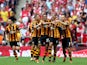 Curtis Davies of Hull City celebrates with team mates as he scores their second goal during the FA Cup with Budweiser Final match between Arsenal and Hull City at Wembley Stadium on May 17, 2014