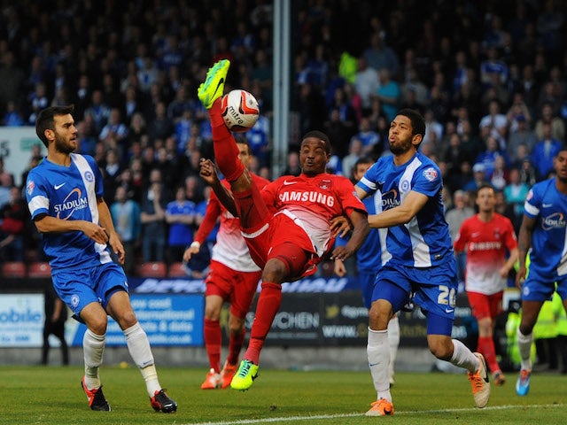 Kevin Lisbie of Leyton Orient challenges for the ball with Nathaniel Knight-Percival of Peterborough United during the Sky Bet League One play-off semi-final second leg match on May 13, 2014