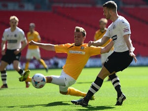 Liam Hughes of Cambridge United battles with Phil Turnbull of Gateshead United during the Skrill Conference Premier Play-Offs Final on May 18, 2014