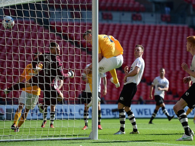 Liam Hughes of Cambridge United scores a goal during the Skrill Conference Premier Play-Offs Final between Cambridge United and Gateshead FC at Wembley Stadium on May 18, 2014