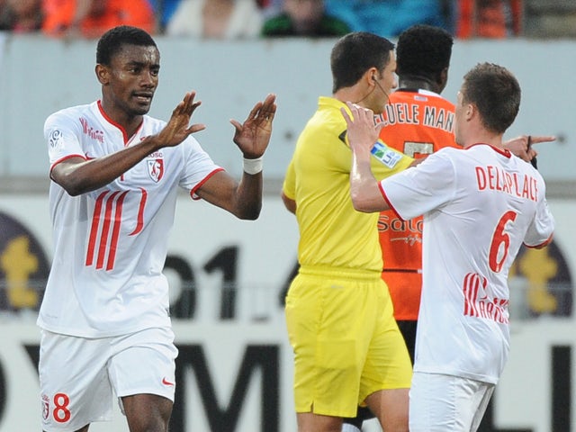 Lille's Ivorian forward Salomon Kalou celebrates after scoring with his teammate Lille's French midfielder Jonathan Delaplace during the French L1 football match Lorient vs Lille on May 17, 2014