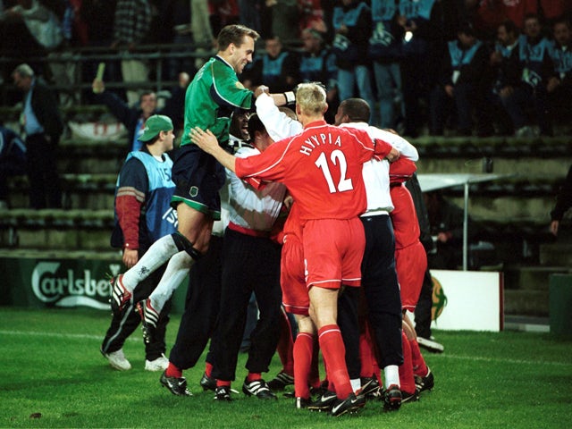 Liverpool players celebrate after Delfi Geli of Alaves scores an own goal to give Liverpool victory in the UEFA Cup Final between Liverpool and Deportivo Alaves on May 16, 2001