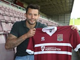 Northampton Town new signing Marc Richards poses with a shirt during a photo call at Sixfields on May 14, 2014