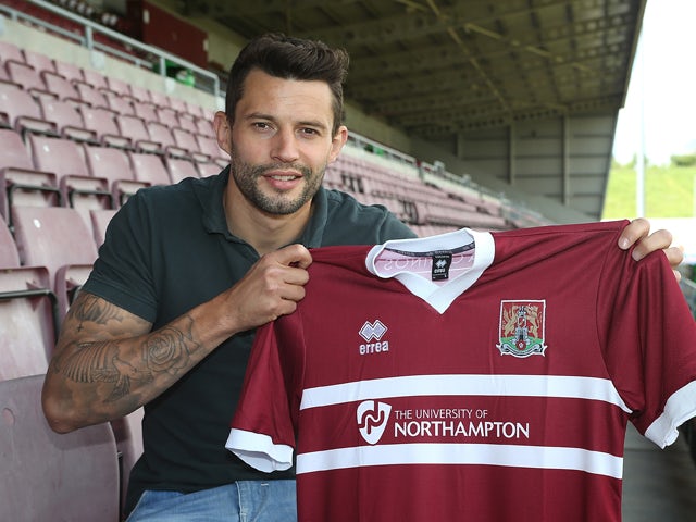 Northampton Town new signing Marc Richards poses with a shirt during a photo call at Sixfields on May 14, 2014