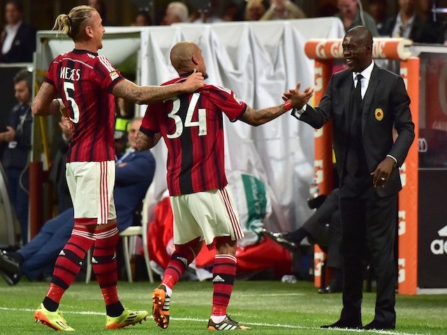 AC Milan's Dutch midfielder Nigel de Jong (C) celebrates after scoring a goal with AC Milan's Dutch coach Clarence Seedorf on May 18, 2014