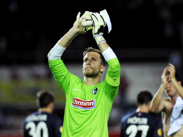 Freiburg's goalkeeper Oliver Baumann acknowledges the crowd at the end of the UEFA Europa league, group H, football match Sevilla FC vs SC Freiburg at the Ramon Sanchez Pizjuan stadium in Sevilla on October 3, 2013