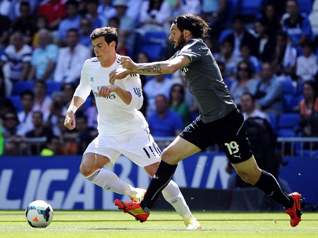 Real Madrid's Welsh forward Gareth Bale vies with Espanyol's Argentinian defender Diego Colotto during the Spanish league football match Real Madrid CF vs RCD Espanyol at the Santiago Bernabeu stadium in Madrid on May 17, 2014