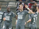 Rennes' teammates celebrate after Rennes' forward Ola Toivonen (2nd R) scores a goal during the French L1 football match between Reims and Rennes, on May 17, 2014
