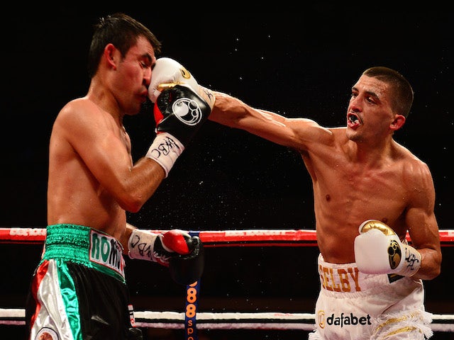 Lee Selby (R) in action against Romulo Koasicha during their WBC International Featherweight Title bout at the Motorpoint Arena on May 17, 2014