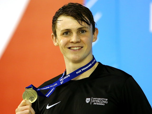 Ross Murdoch poses with his medal on the podium after winning the Men's 100m Breaststroke Final on day three of the British Gas Swimming Championships 2014 at Tollcross International Swimming Centre on April 12, 2014