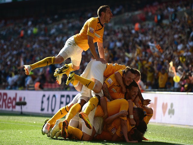 Ryan Donaldson of Cambridge United celebrates his goal with team mates during the Skrill Conference Premier Play-Offs Final against Gateshead on May 18, 2014