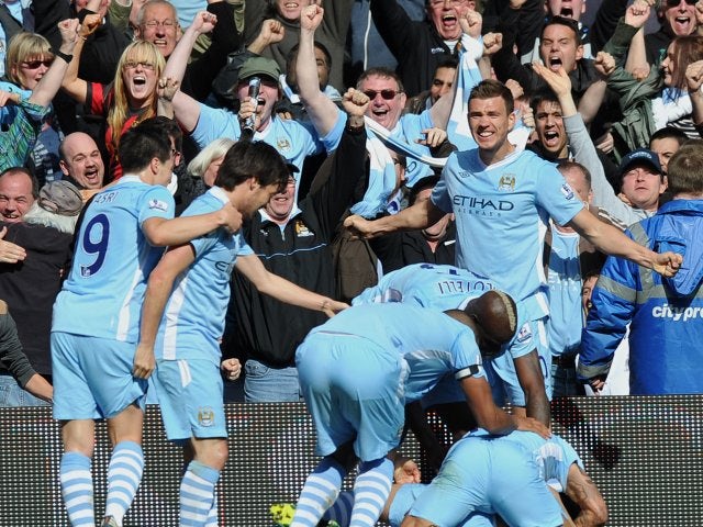 Manchester City players celebrate Sergio Aguero's late title-clinching goal against Queens Park Rangers on May 13, 2012.