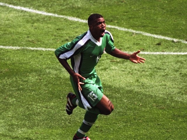 Midfielder Sunday Oliseh celebrates scoring at the World Cup on June 13, 1998.