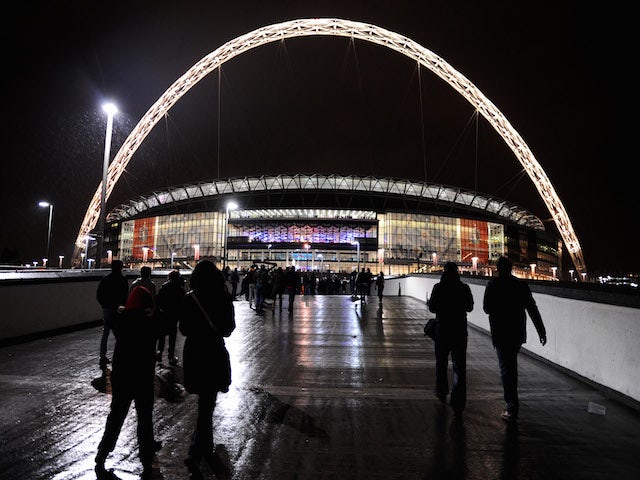 Fans walk to the stadium prior to the FIFA 2014 World Cup Qualifying Group H match between England and Montenegro at Wembley Stadium on October 11, 2013
