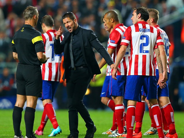  Diego Simeone, Coach of Club Atletico de Madrid speaks to Referee Bjorn Kuipers during the UEFA Champions League Final between Real Madrid and Atletico de Madrid at Estadio da Luz on May 24, 2014