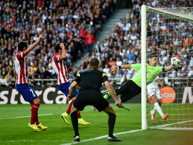Iker Casillas of Real Madrid fails to stop the ball headed in by Diego Godin of Club Atletico de Madrid (not pictured) for the first goal during the UEFA Champions League Final between Real Madrid and Atletico de Madrid at Estadio da Luz on May 24, 2014