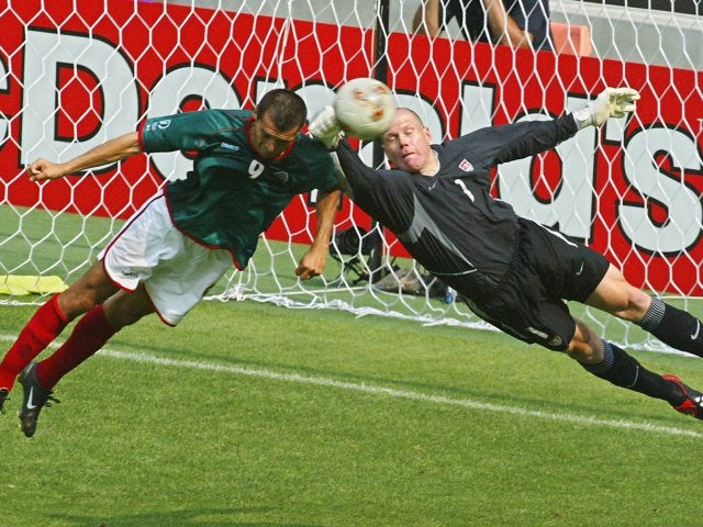 USA goalkeeper Brad Friedel punches the ball clear during a match against Mexico on June 17, 2002.