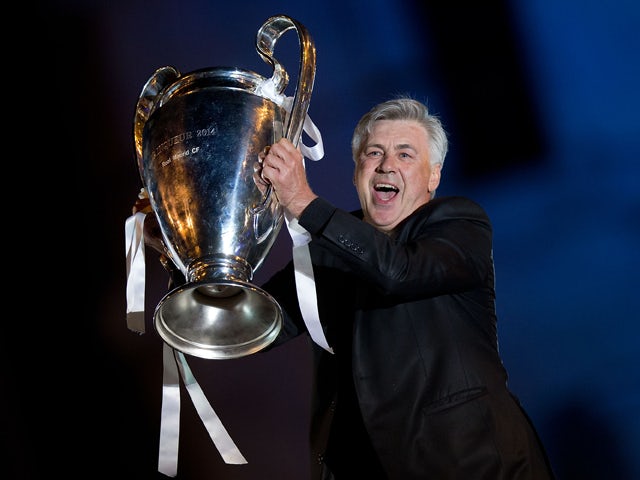 Head coach Carlo Ancelotti of Real Madrid CF holds the UEFA Champions League cup celebrating their victory on the UEFA Champions League Final match against Club Atletico de Madrid at Cibeles square on the early morning of May, 25, 2014