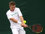 Daniel Cox of Great Britain returns a shot during his first round match against Sergiy Stakhovsky of Ukraine on Day Two of the Wimbledon Lawn Tennis Championships at the All England Lawn Tennis and Croquet Club on June 21, 2011