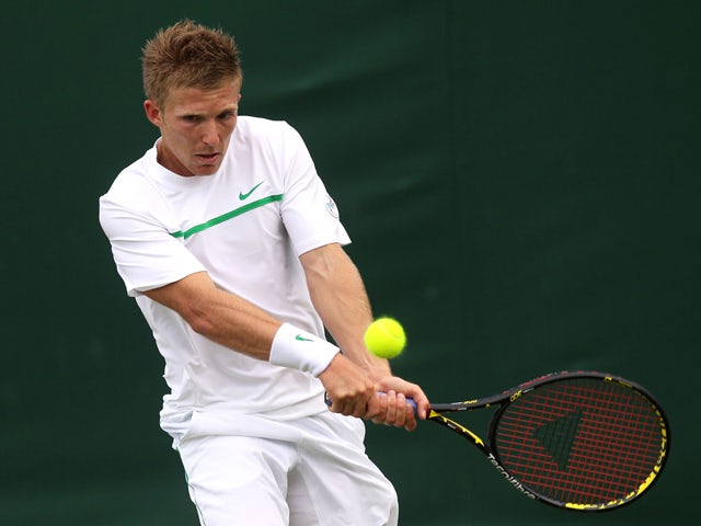 Daniel Cox of Great Britain returns a shot during his first round match against Sergiy Stakhovsky of Ukraine on Day Two of the Wimbledon Lawn Tennis Championships at the All England Lawn Tennis and Croquet Club on June 21, 2011