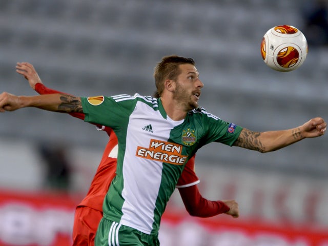 SK Rapid Wien's midfielder Guido Burgstaller tries to head the ball during the Europa League group G football match between FC Thun and SK Rapid Wien on September 19, 2013