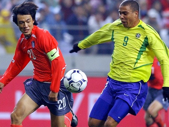 South Korea defender Hong Myung-bo battles for possession with Brazilian international Ronaldo on November 20, 2002.