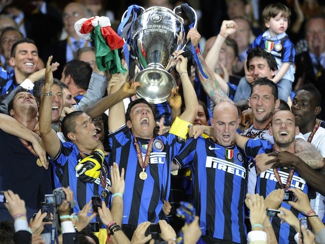 Inter Milan's players celebrate with the trophy after winning the UEFA Champions League final football match Inter Milan against Bayern Munich at the Santiago Bernabeu stadium in Madrid on May 22, 2010