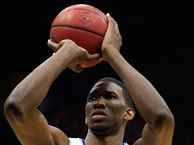 Joel Embiid #21 of the Kansas Jayhawks shoots a free throw during the game against the Iowa State Cyclones at Allen Fieldhouse on January 29, 2014