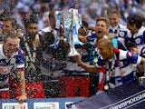 : The QPR team celebrate with the trophy after the Sky Bet Championship Playoff Final match between Derby County and Queens Park Rangers at Wembley Stadium on May 24, 2014