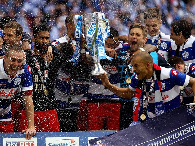 : The QPR team celebrate with the trophy after the Sky Bet Championship Playoff Final match between Derby County and Queens Park Rangers at Wembley Stadium on May 24, 2014