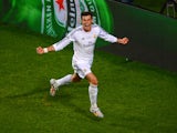 Gareth Bale of Real Madrid celebrates scoring their second goal in extra time during the UEFA Champions League Final between Real Madrid and Atletico de Madrid at Estadio da Luz on May 24, 2014