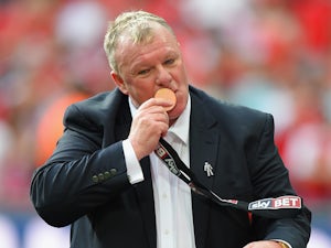 Rotherham manager Steve Evans kisses his medal after the Sky Bet League One Playoff Final between Leyton Orient and Rotherham United at Wembley Stadium on May 25, 2014