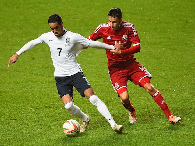 Tom Ince of England battles with Tom O'Sullivan of Wales during the 2015 UEFA European U21 Championships Qualifier on May 19, 2014