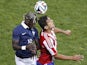 France's defender Bacary Sagna (L) vies with Paraguay's forward Roque Santa Cruz (R) during their international friendly football match France vs Paraguay, on June 01, 2014 