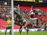 The ball goes over Burton Albion's English goalkeeper Dean Lyness (L) during the English League 2 Play-Off final football match between Burton Albion and Fleetwood Town on May 26, 2014