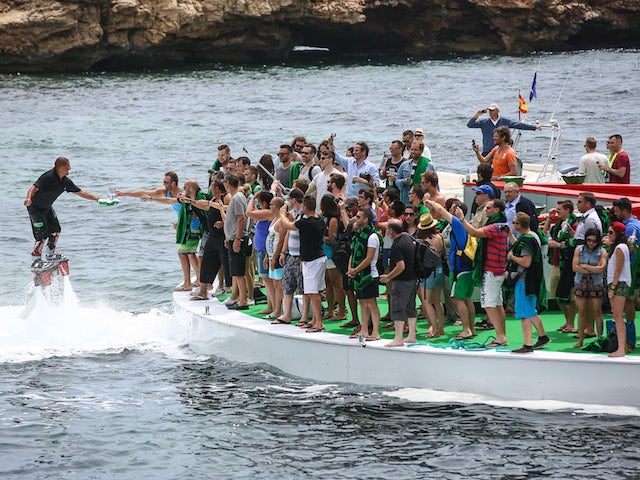 Flyboard waiters serve guests on the floating bar at the Heineken Ibiza Final on May 24, 2014