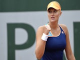 France's Kristina Mladenovic reacts during her French tennis Open first round match against China's Li Na at the Roland Garros stadium in Paris on May 27, 2014